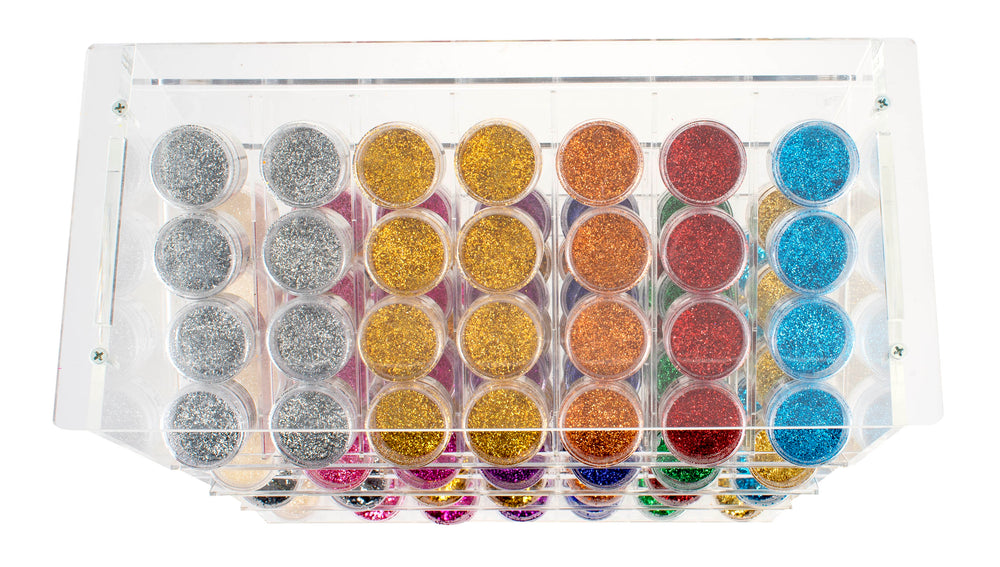 Die Draufsicht auf das Glorex Bio-Glitter Display 112tlg zeigt Reihen von kleinen Behältern mit buntem, umweltfreundlichem, biologisch abbaubarem Bio-Glitter in Silber-, Gold-, Orange-, Rot-, Blau- und Pink-Tönen.