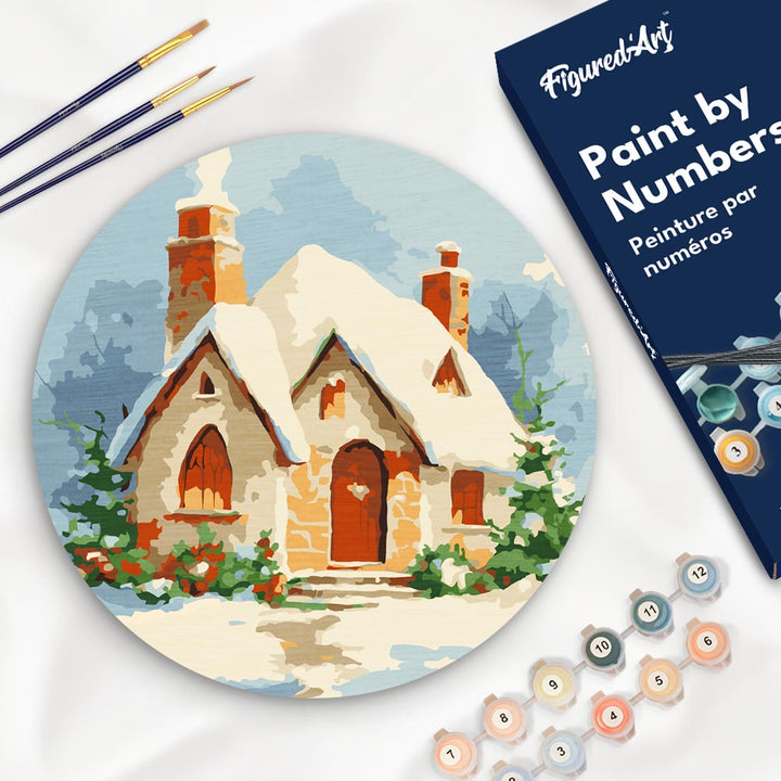 Malen nach Zahlen auf Holzscheibe – Backsteinhaus im Schnee